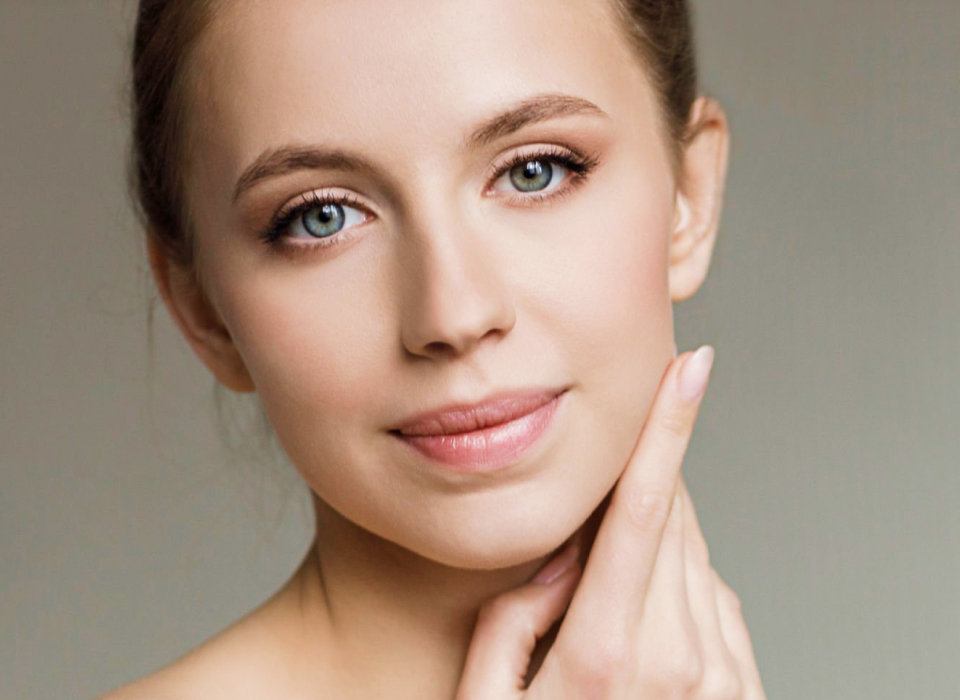 Beautiful young woman cares for the skin face