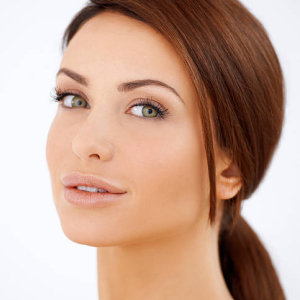 Closeup facial portrait of a beautiful sensual brunette woman with lovely fresh skin