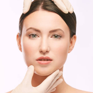 Doctor in gloves touch woman face