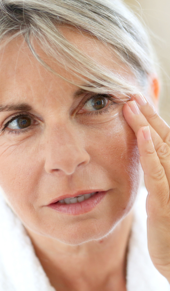 Portrait of middle aged woman face holding fingers near eye