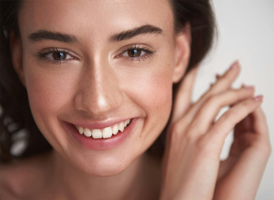 Close up portrait of happy smiling young brunette pretty lady with clean skin