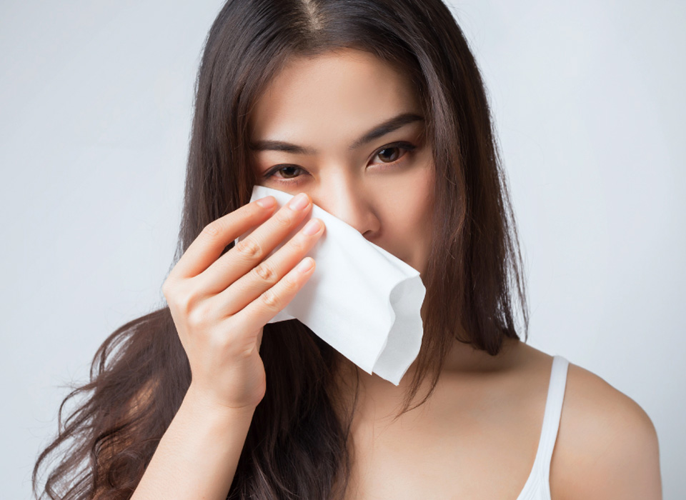 Young Asian woman wipe her face with handkerchief
