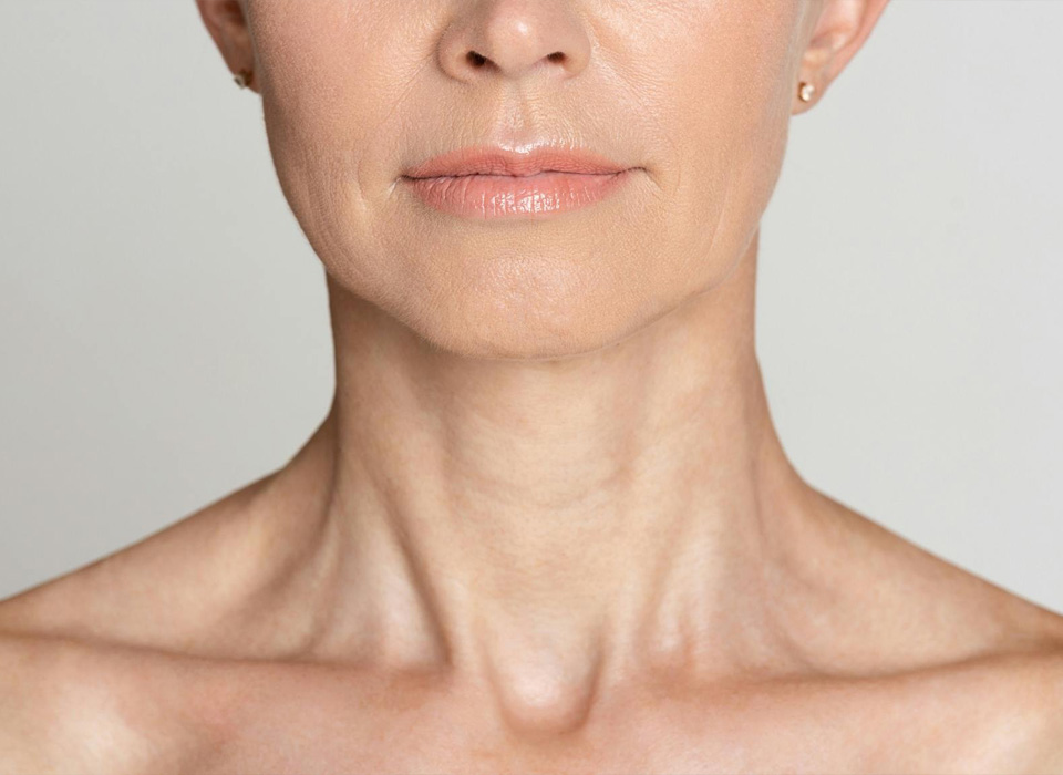Half face portrait of mature woman with wrinkled neck