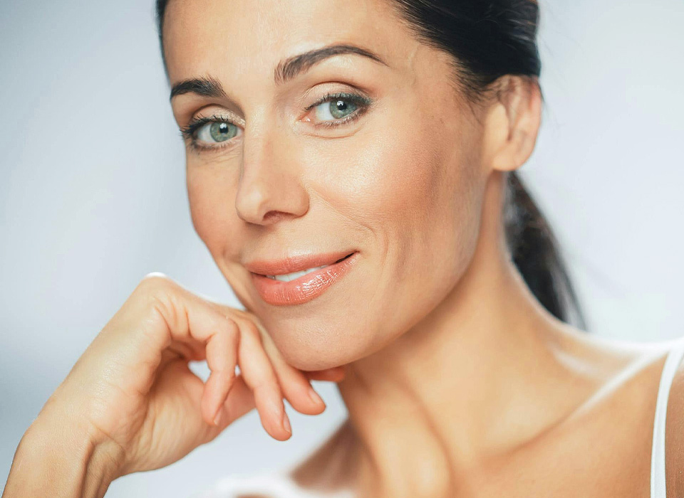 Beautiful Caucasian Woman Touches Her Perfect Face