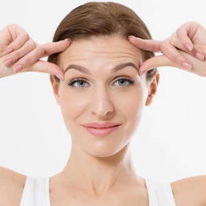 Macro Woman face with wrinkles on the forehead